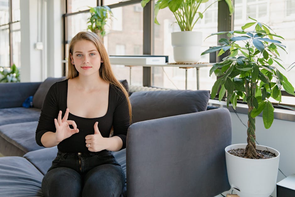 Peaceful woman with healthy bright eyes sitting in comfortable humid indoor environment with lush green plants and modern humidifier creating optimal air quality for eye comfort