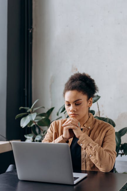 Professional person working comfortably at computer workstation with relaxed focused eyes in humid office environment featuring green plants and optimal air quality for extended screen time